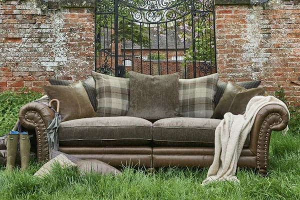 stylish shot of an Alexander & James sofa outside near a garden wall