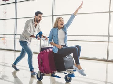 couple with luggage in an airport